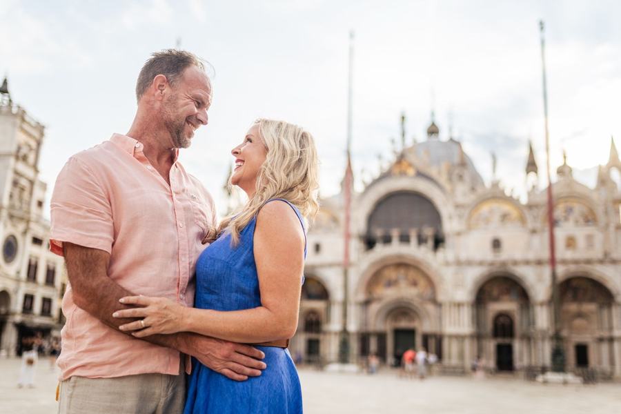 A couple holding each other in front of St Mark's Basilica